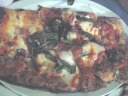 Perhaps this is the "Safe'n Sound: fresh tomatoes, fresh mozarella,
asiago, basil and fried garlic"?

